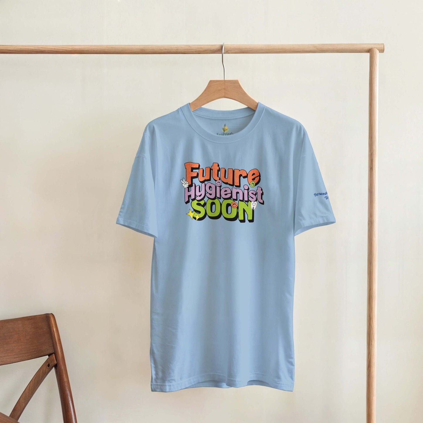 Future Hygienist Soon personalized heavyweight unisex crewneck T-shirt in light blue hanging on display.