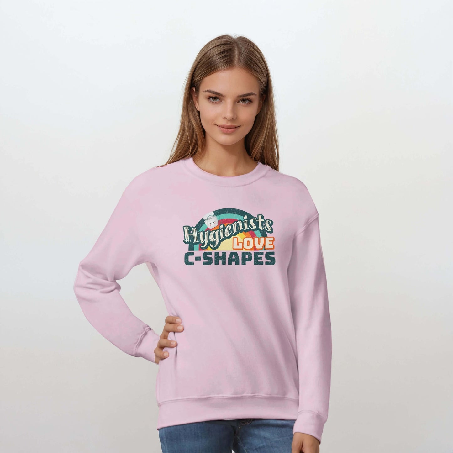 Woman wearing pink sweatshirt featuring "Hygienists LOVE C-Shapes" graphic, showcasing personalized classic unisex design.