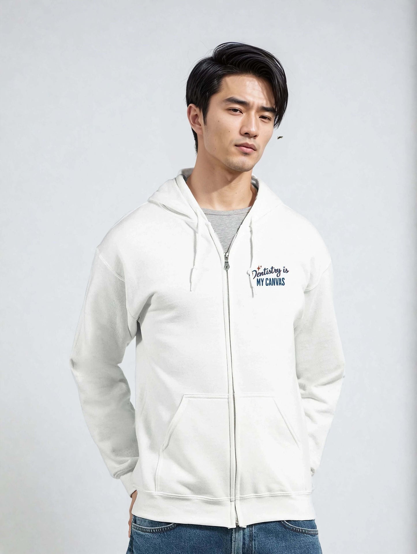 Personalized Classic Unisex Zip Hoodie in white with 'Dentistry is My Canvas' embroidery on chest.