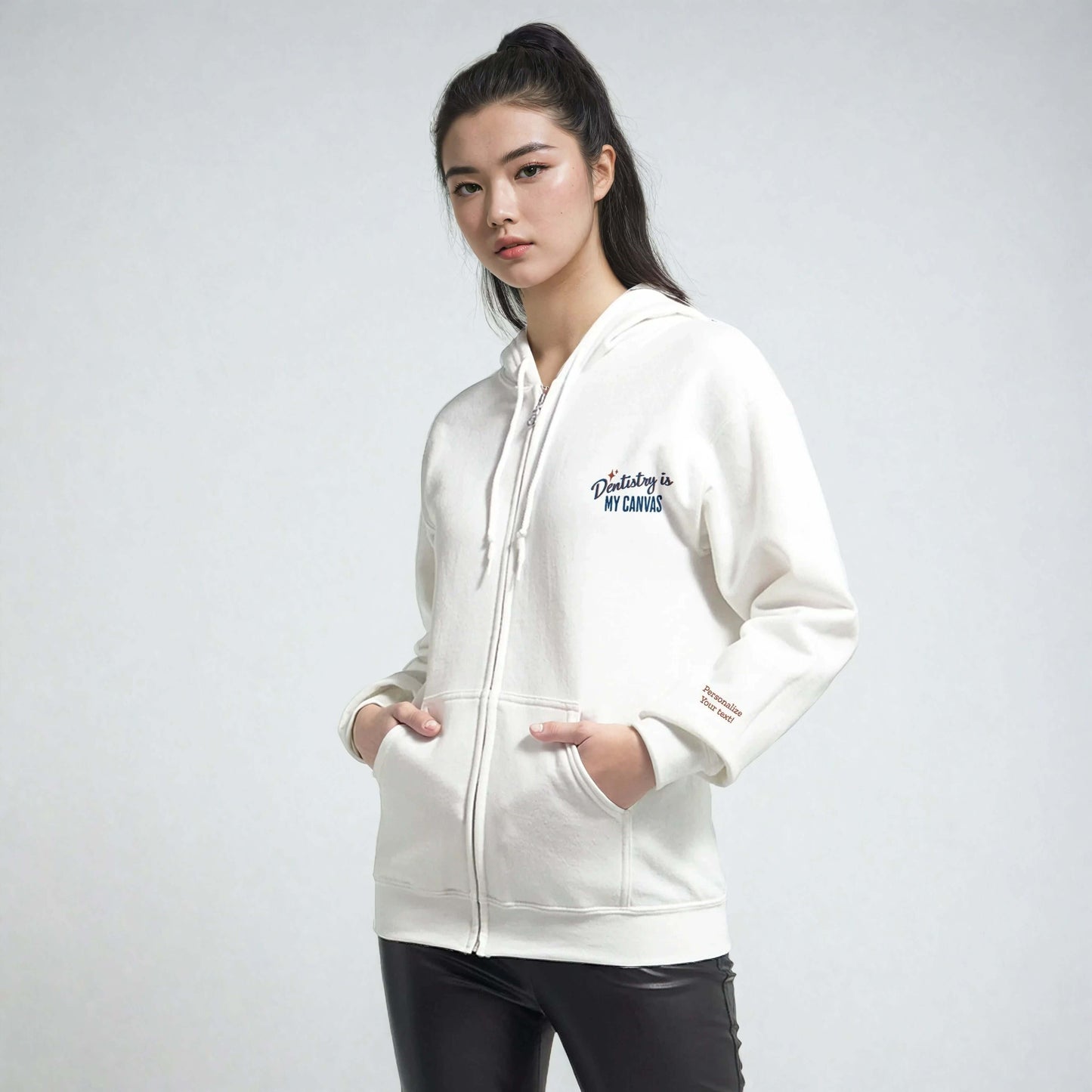 Model wearing a Personalized Classic Unisex Zip Hoodie with 'Dentistry is My Canvas' embroidery, showcasing eco-friendly materials.