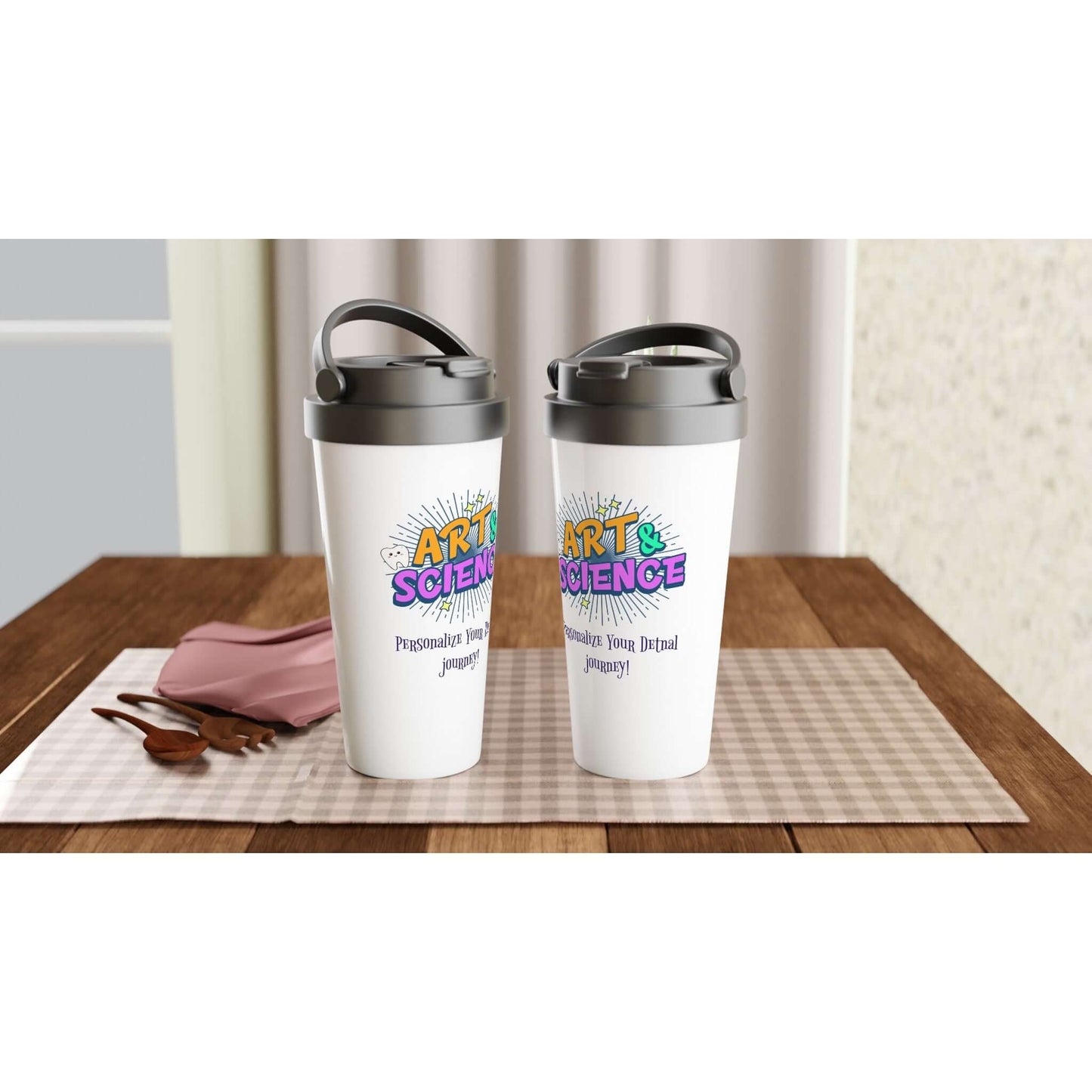 Art & Science personalized 15oz stainless steel travel mugs on a table with a cozy setting.