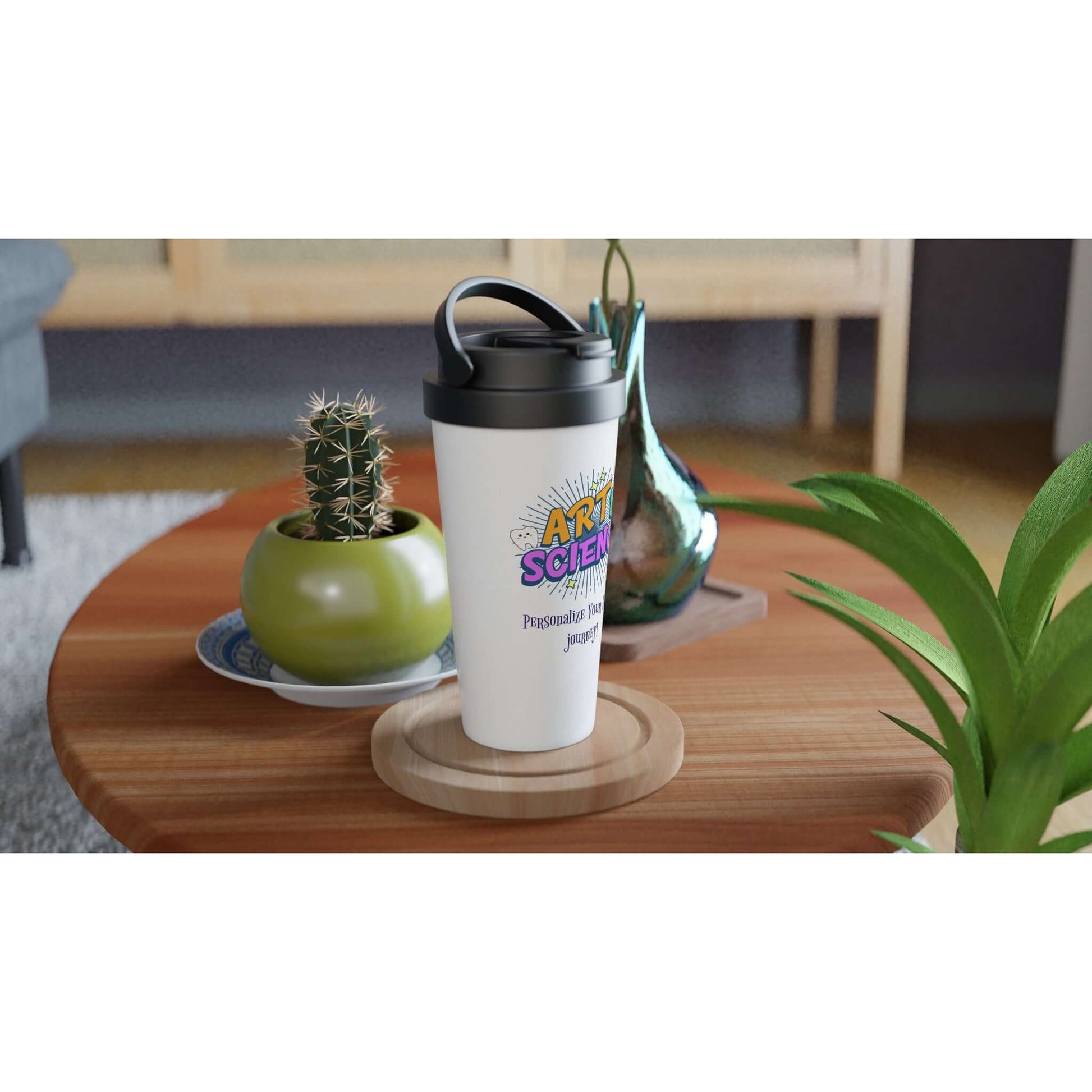 Art & Science personalized 15oz stainless steel travel mug on a wooden table surrounded by plants and decor.