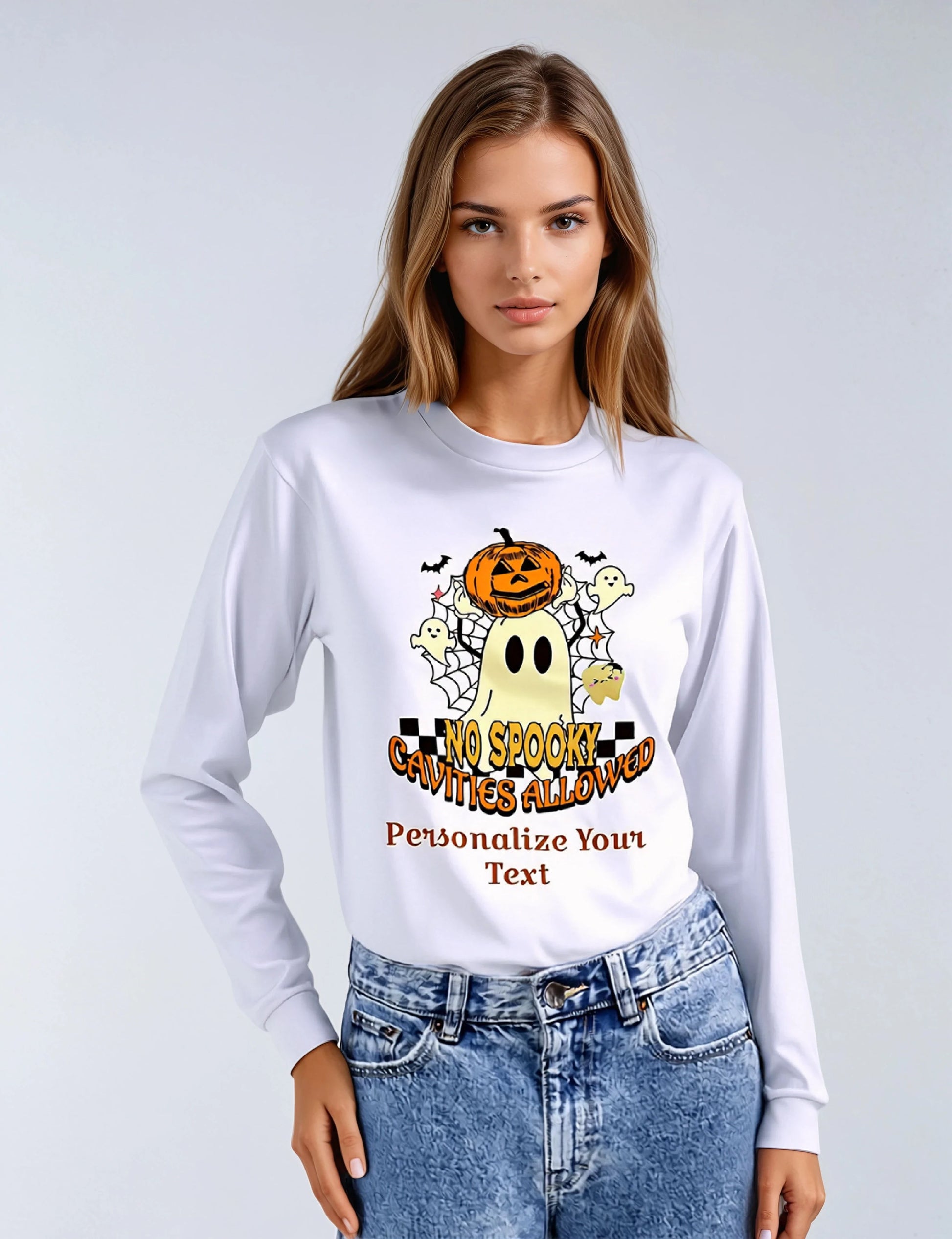 Woman wearing a white long-sleeve shirt with Halloween-themed design and text.