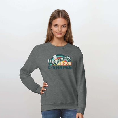 Model wearing a gray personalized crewneck sweatshirt with 'Hygienists LOVE C-Shapes' graphic in front.
