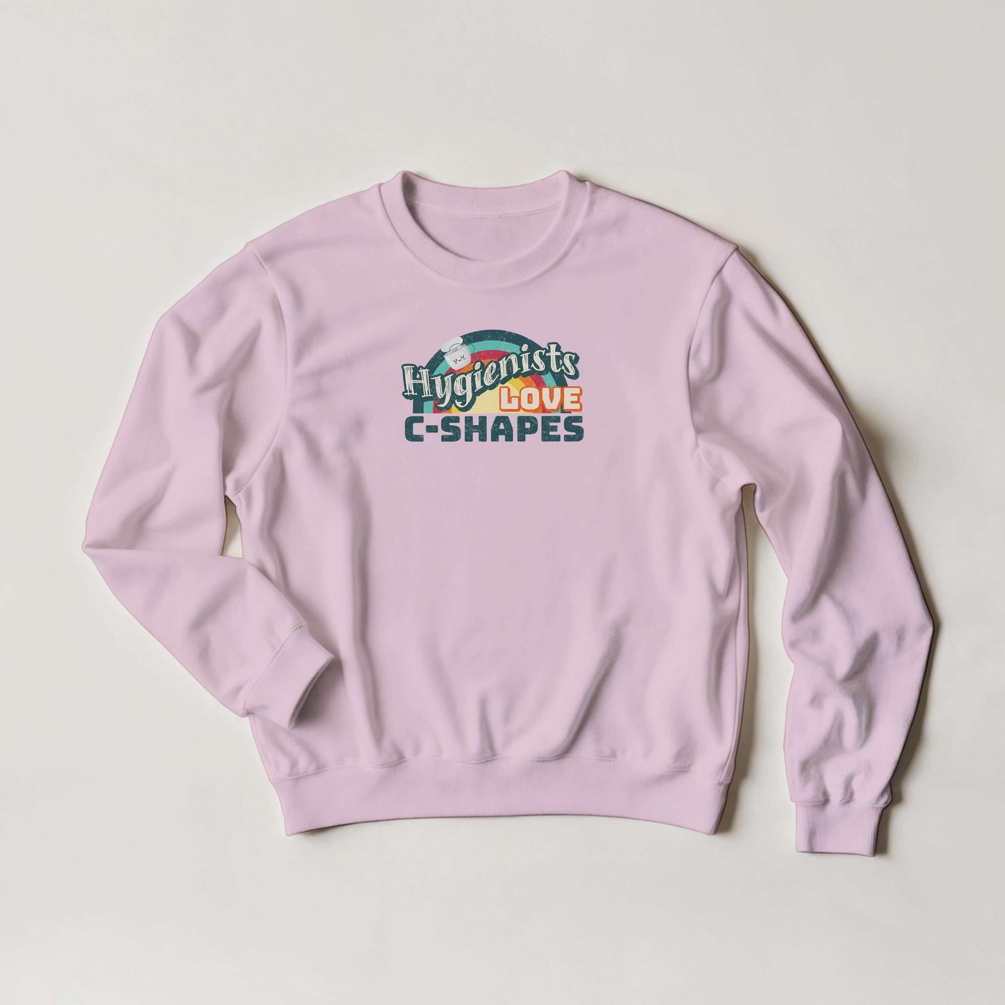 Pink Gildan® 18000 sweatshirt featuring 'Hygienists LOVE C-Shapes' graphic on front.