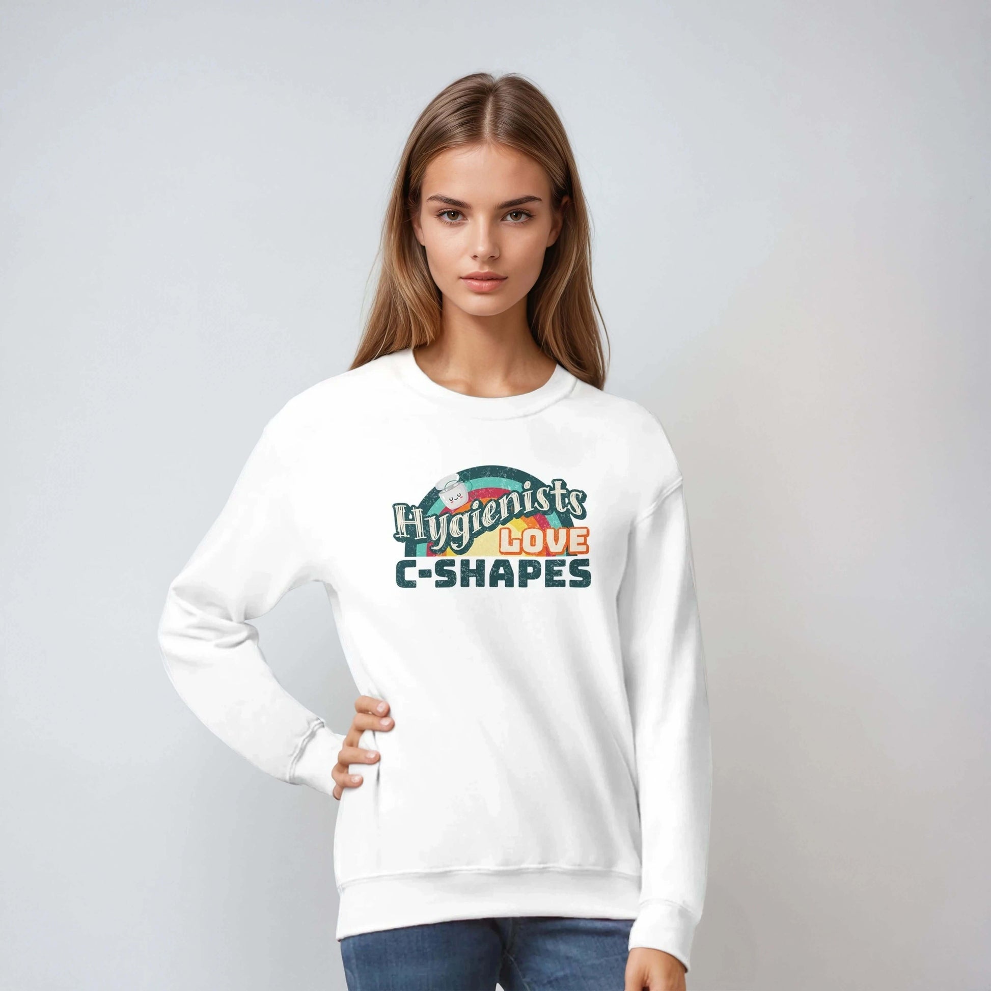Model wearing Hygienists LOVE C-Shapes personalized crewneck sweatshirt in white, showcasing playful dental pride design.