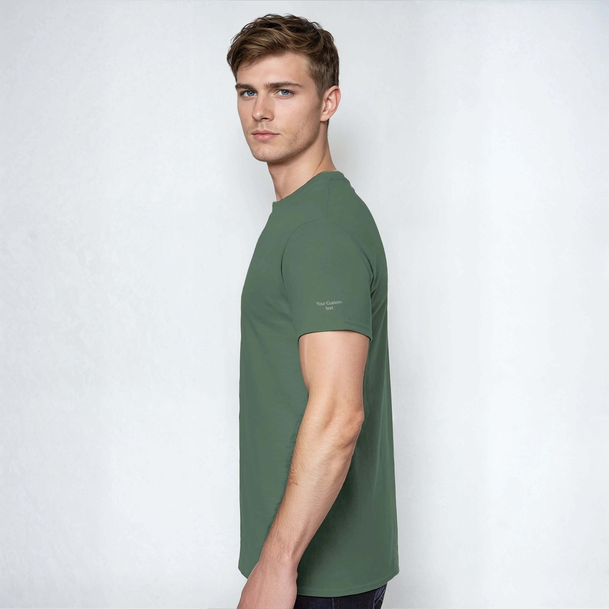 Profile view of a model wearing a Personalized Heavyweight Unisex Crewneck T-Shirt in dark green.